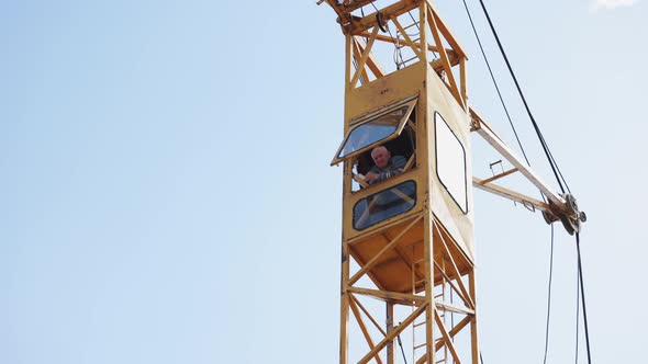 Worker in the Cockpit of a Crane