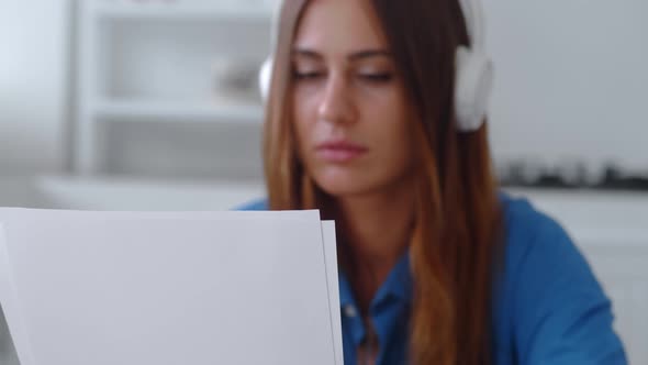 Frustrated Young Woman Reading Paper Letter with Bad News