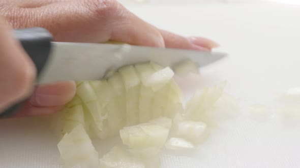 White Allium cepa vegetable cutting on white board  in the kitchen  4K 2160p 30fps UHD footage - Clo