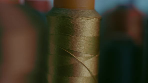 Spools of Thread for Sewing Shoes in Dark Colors Stand on a Shelf