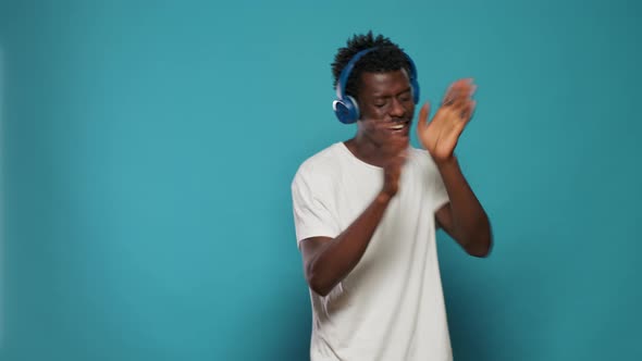 African American Man with Headphones Listening to Music