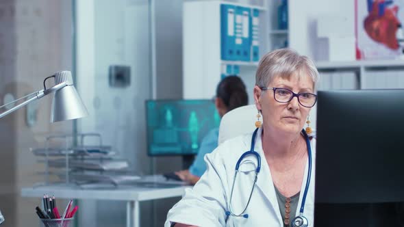 Portrait of Senior Doctor Woman Working