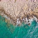 Aerial Top View Of Cliffs Of A Rocky Coast With Turquoise Sea - VideoHive Item for Sale