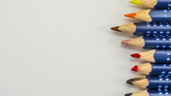 Row of color pencils moving in seamless stop motion loop 4k