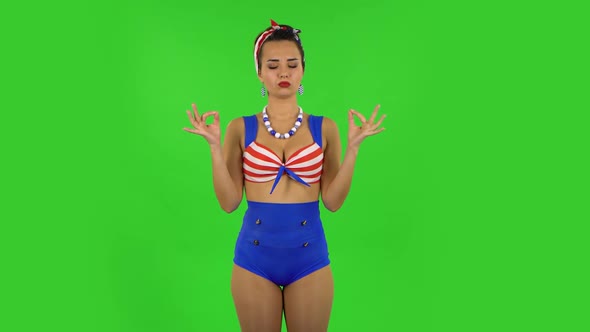 Beautiful Girl in a Swimsuit Is Relaxing and Meditating. Green Screen