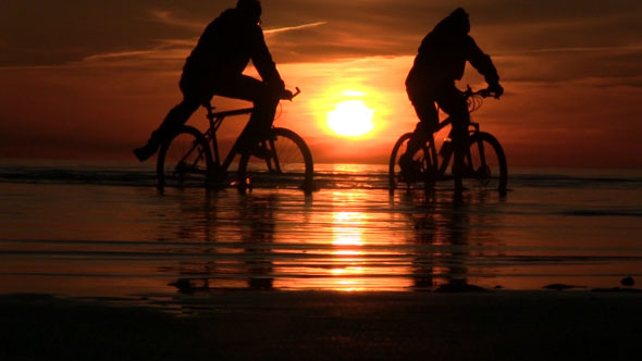 Bicycles In The Sea During Sunset