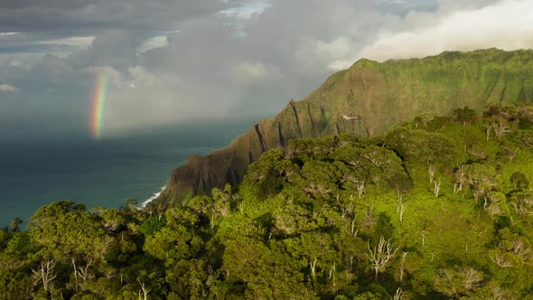 Beautiful Kauai Coastline Arial with Rainbow in Cloudy Sky at Sunset  Footage