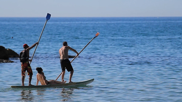 3 People Cruising on a Standup Paddle