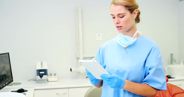 Smiling nurse using digital tablet