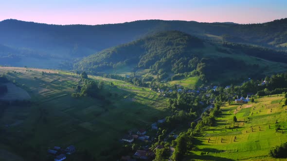 Drone Flies Above Small Town in Highland