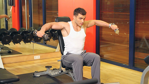 Muscular Man Exercising at the Gym