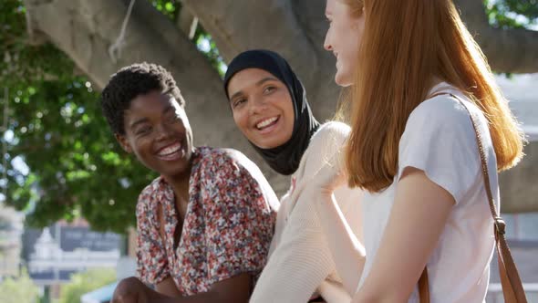 Young adult female friends hanging out together