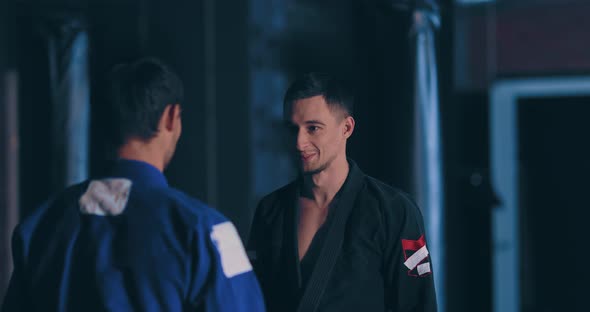 Men Judokas Look at Each Other and Laugh