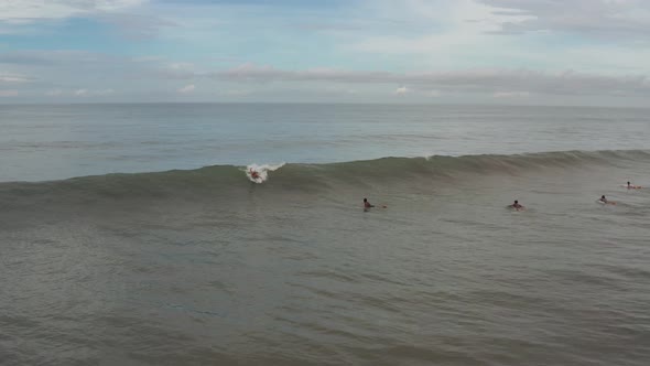 Aerial View of Surfer Riding Blue Ocean Wave. Drone  Shot Surfing Ocean Lifestyle, Extreme Sports