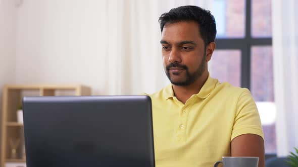 Man with Laptop Working at Home Office