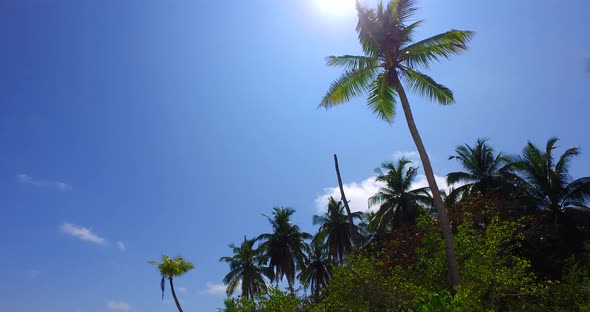 Wide overhead copy space shot of a sandy white paradise beach and turquoise sea background in colour