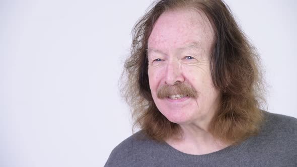 Happy Senior Man with Mustache Smiling While Thinking