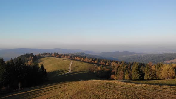 Flight over autumn mountains in the light of the setting sun