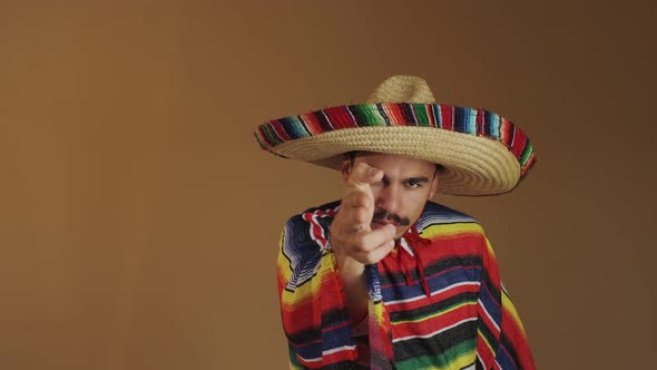 Young Mexican In Multicolored Poncho And Hat