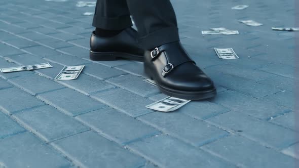 Close Up of Businessman's Feet Becoming Shoes on 100 Dollar Bills