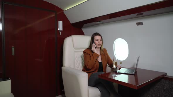 Young Woman in Airplane Flying Girl in Private Jet or First Business Class