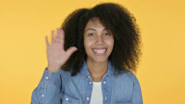 African Woman Waving, Yellow Background 