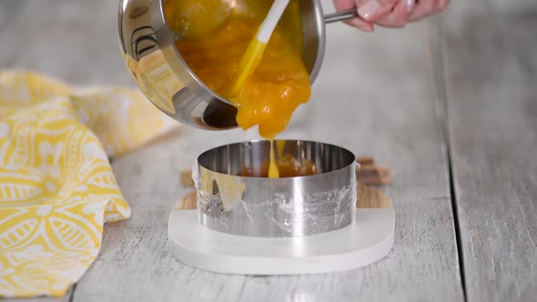 Pouring peach jelly into the metal ring, Making peach filling for mousse cake