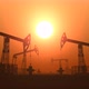 Working Oil Pump Jacks in a Desert against Sunset Extracting Crude Oil - VideoHive Item for Sale
