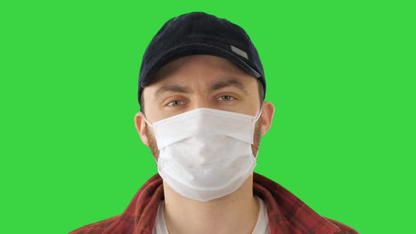 American Farmer Wearing the Protective Medical Mask Looking To Camera on a Green Screen, Chroma Key.