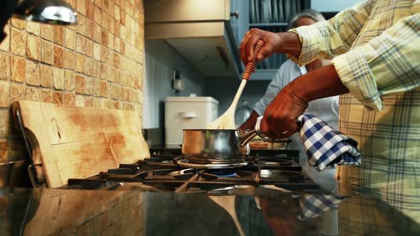 Senior couple preparing food in kitchen