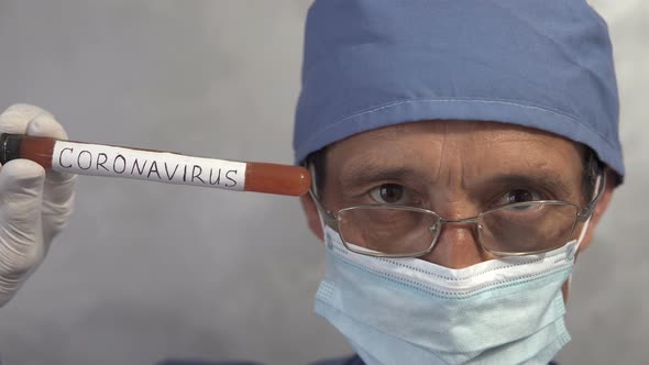 A doctor holds a test tube with a covid-19 test vaccine in his hand.