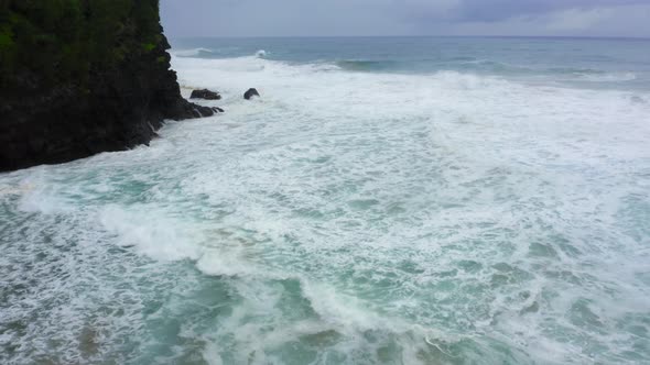 Aerial Footage Over Peaceful Seascape of Pacific Ocean Surf at the Rocky Hawaiian Coastline