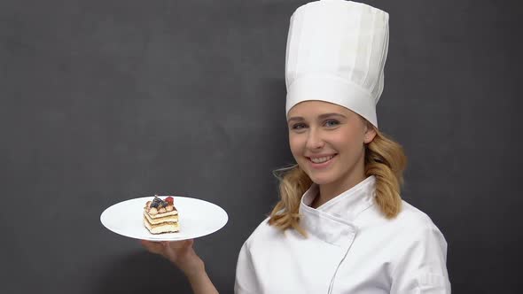 Attractive Lady Cook Demonstrating Appetizing Cake on Plate, Culinary and Bakery