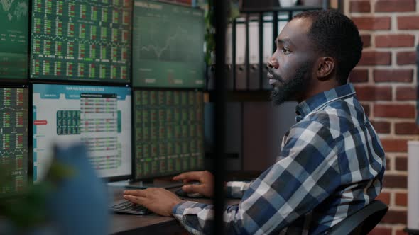 Male Investor Using Forex Exchange Fund Sales on Multiple Monitors