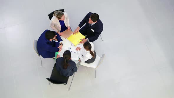 Businesspeople discussing during meeting in office