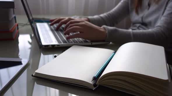 The girl working at home office hands on keyboard.