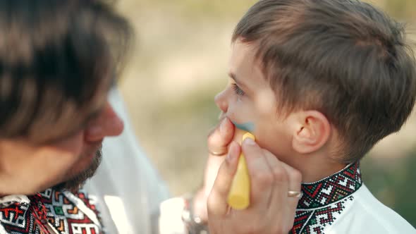 Dad Draws Yellowblue Flag of Ukraine on His Son's Cheek