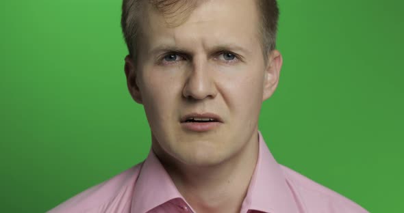 Face of Young Depressed Man Crying on Green Chroma Key Background