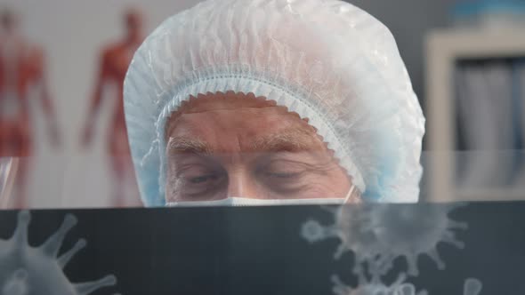 Scientific Researcher Holding Image of Bacteria While Studying New Virus alt