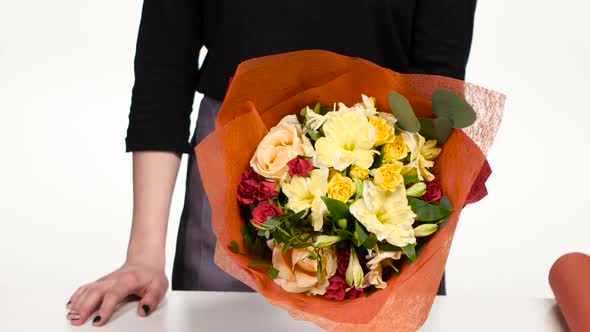 Florist Turns a Beautiful Colorful Bouquet. White. Close Up