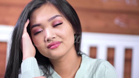Closeup Face of Pretty Smiling Young Asian Female Model Wearing Natural Makeup Looking at Camera