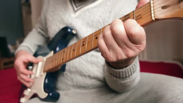 Senior Man is Playing Guitar