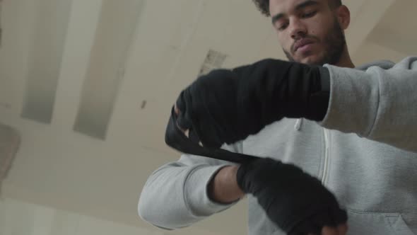 Afro Sportsman Wrapping Hands Before Kickboxing