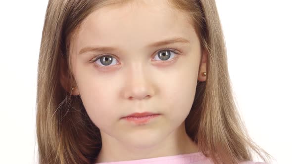 Child Genuinely Smile at the Camera. White Background. Close Up