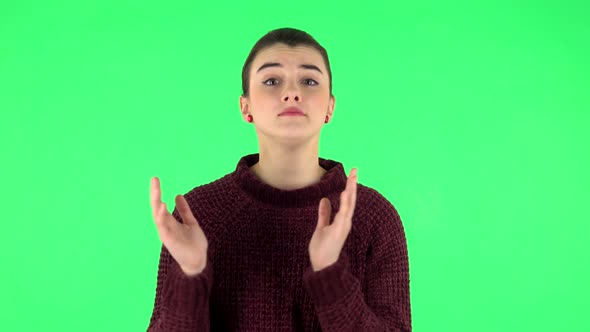 Girl Claps Her Hands Indifferently. Green Screen