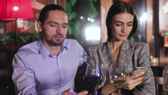 Communication Problem. People Using Phone On Date At Restaurant