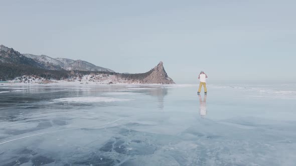 Aerial View of Man Skating on Lake Baikal Covered By Ice