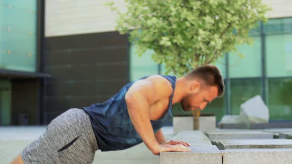 Young Man Doing Push Ups on City Street