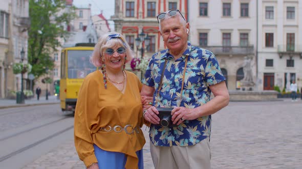 Senior Couple Grandmother Grandfather Tourists Talking on City Street Holidays Vacation Traveling