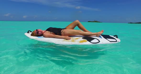 Beautiful fun women on holiday enjoying life at the beach on summer white sandy and blue 4K backgrou